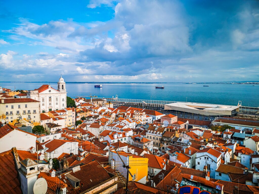 View of Lisbon Alfama neighborhood and Tagus River at sunset Portugal