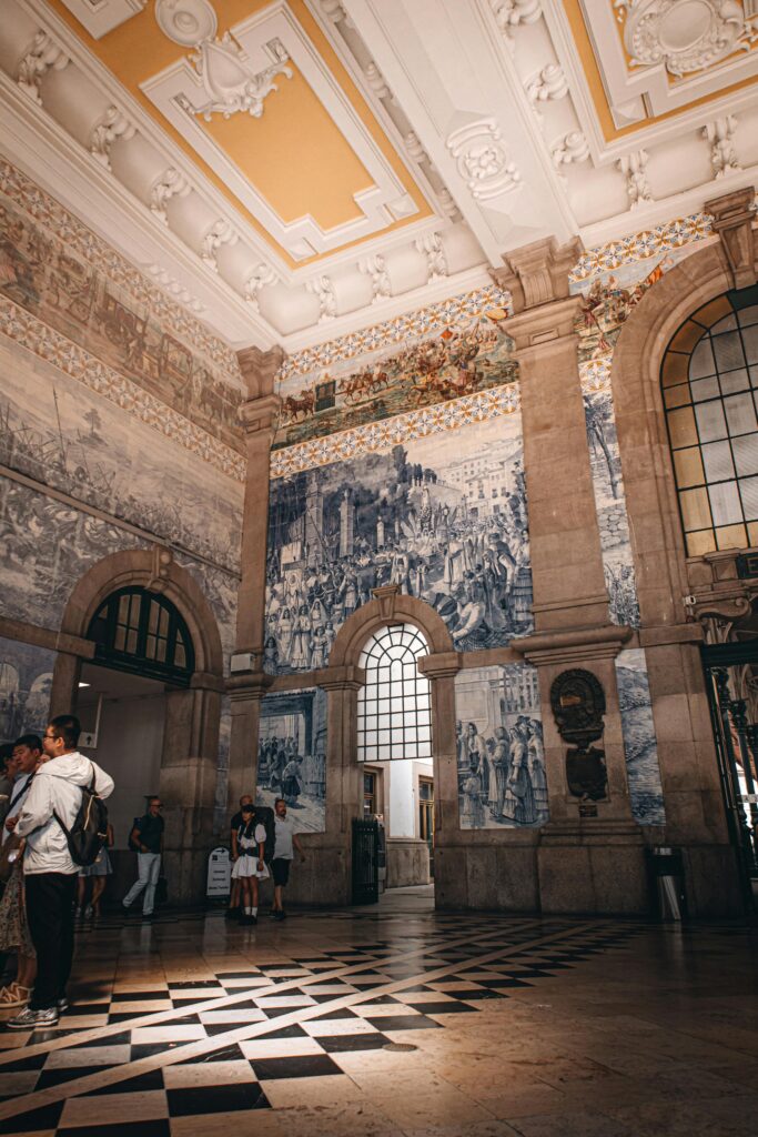 Blue and white azulejo tiles inside Sao Bento train station in Porto Portugal