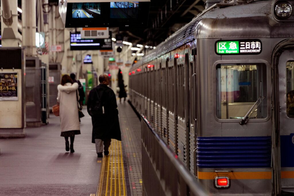 Osaka Metro station interior showing bilingual English and Japanese directional signage
