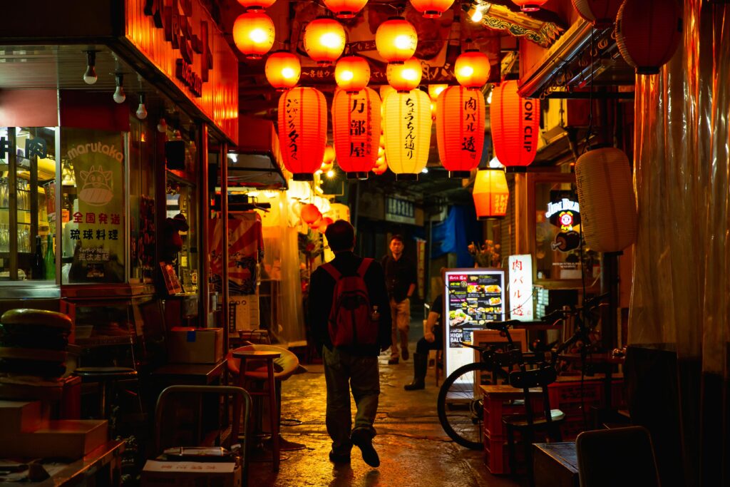 Hozenji Yokocho alley in Osaka lit by traditional lanterns with small restaurants lining both sides